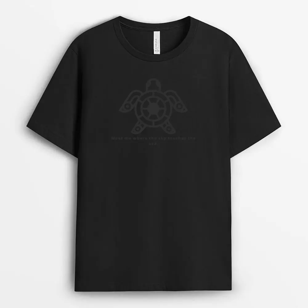 Clean flat lay of a soft blue tee with horizon-line artwork, showcasing light ribbing at the collar and side-seam detail, inspired by the ocean's meeting point with the sky.