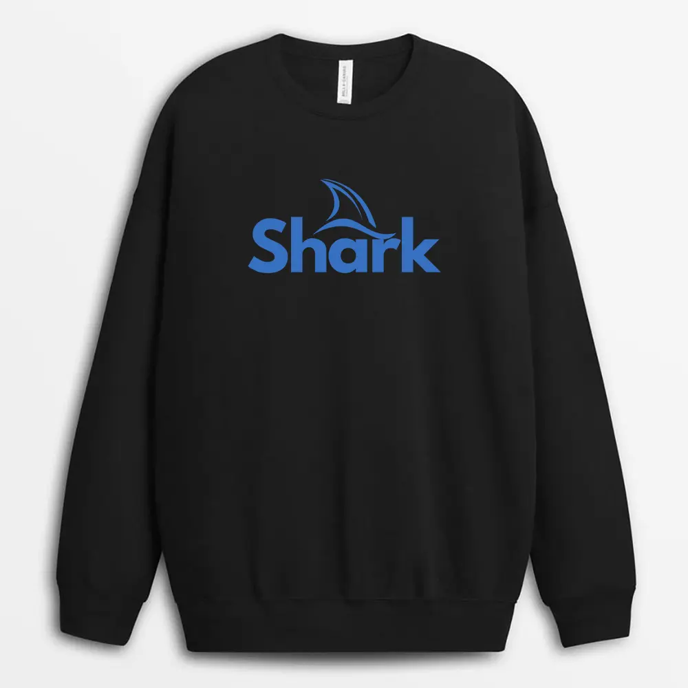 Lifestyle photo of a person standing by the sea wearing a dusty blue sweatshirt with subtle ocean graphics and a brave, minimalist quote across the back.