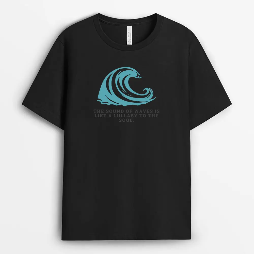 Soft pink T-shirt placed near seashells and ocean stones, featuring a faded wave graphic and relaxed neckline, capturing the spirit of calm and restoration.